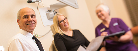 Dr. John Forest III with nurse and patient